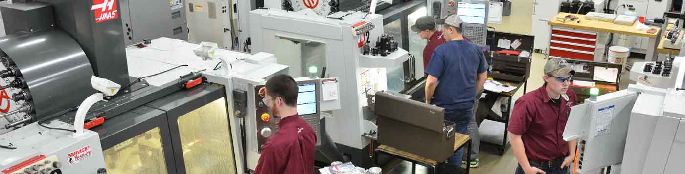 A group of young men working at a local manufacturing company.